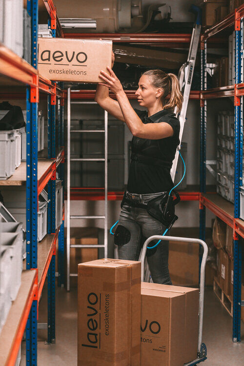 Warehouse worker using the Laevo exoskeleton suit